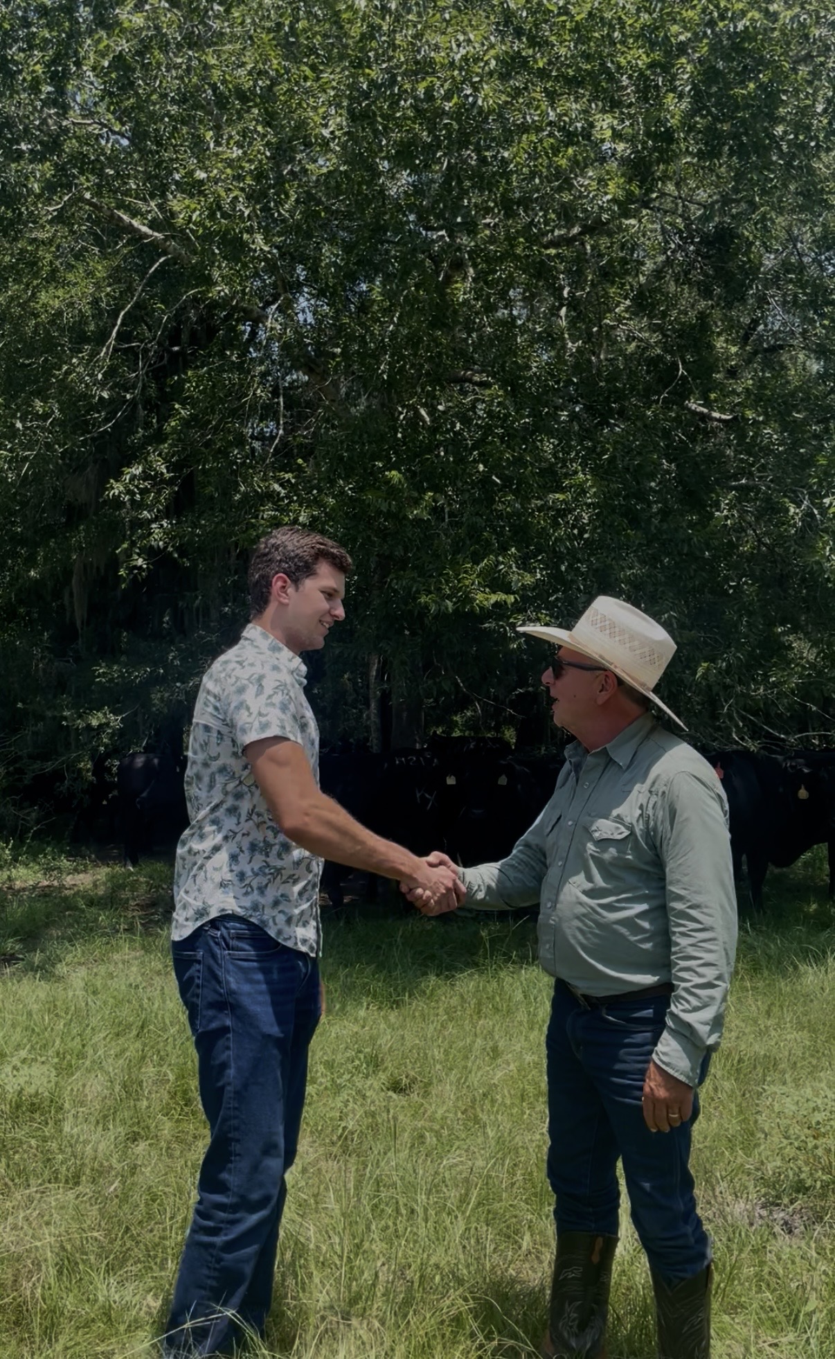 Michael Borchers shaking hands with a Winch Ranch cattleman